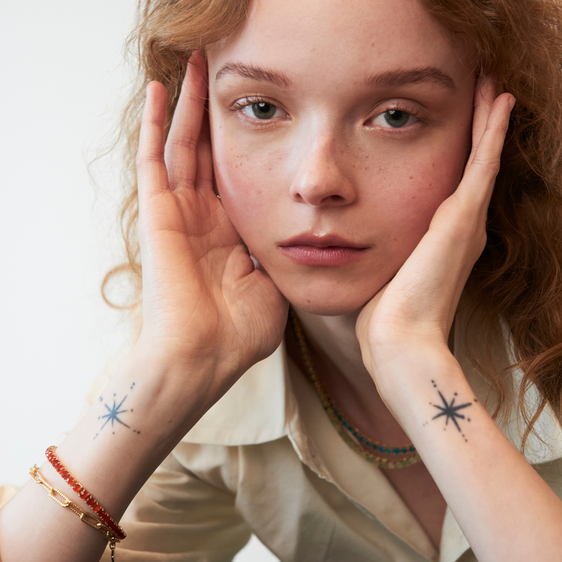 model wearing gold bracelets including the 4mm carnelian tennis bracelet