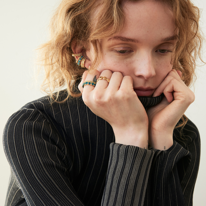 model wearing gemstone ear cuffs and band rings including the 4mm apatite eternity band ring