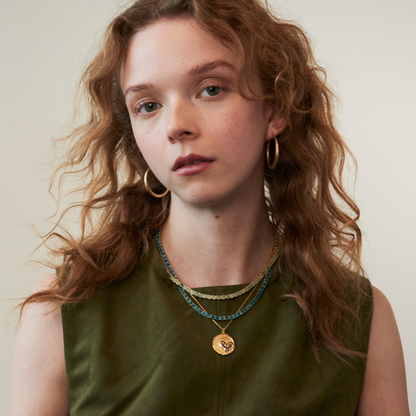 model wearing the 4mm apatite tennis necklace along with the heart pendant necklace