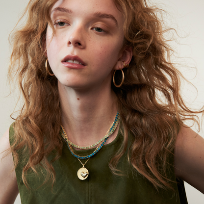 model wearing the heart pendant necklace along with the 4mm aventurine tennis necklace and apatite necklace