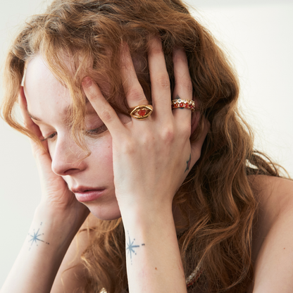 model wearing statement rings including the carnelian heart lips ring