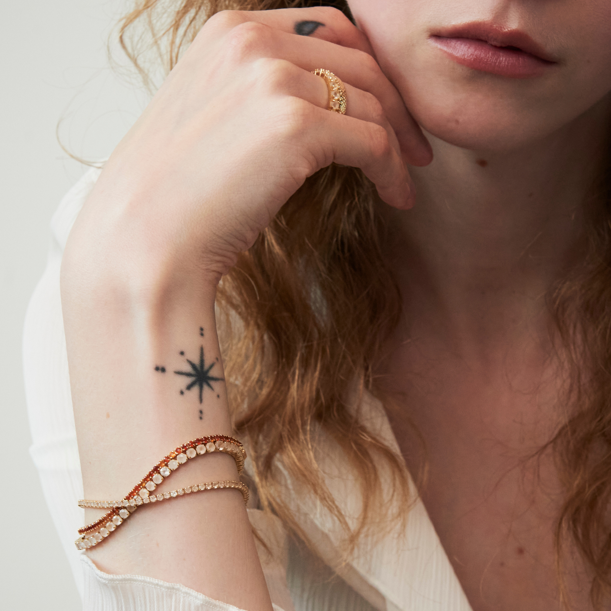 model wrist showing gold tennis bracelets including the 2mm carnelian tennis bracelet 