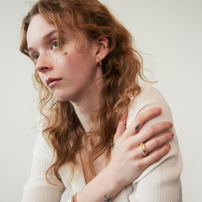 model wearing gold jewellery including the crystal quartz mini tennis earrings