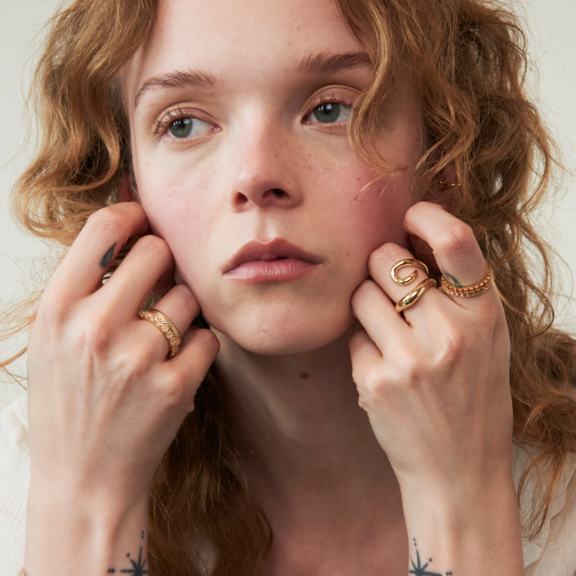 model wearing statement rings including the abstract heart ring and endless hearts ring