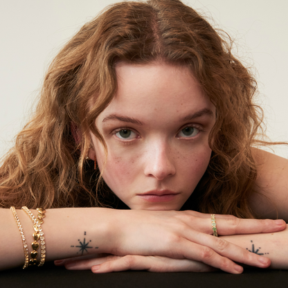 model wearing the 3mm crystal quartz tennis bracelet along with the endless hearts bracelet and other tennis pieces