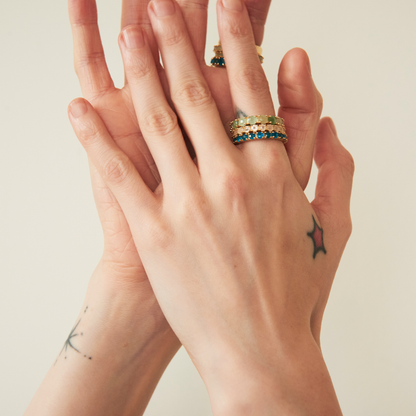 model hands wearing eternity band rings including the 3mm rose quartz eternity band ring
