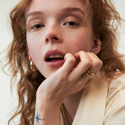 model wearing gold band rings including the 4mm rose quartz eternity band ring