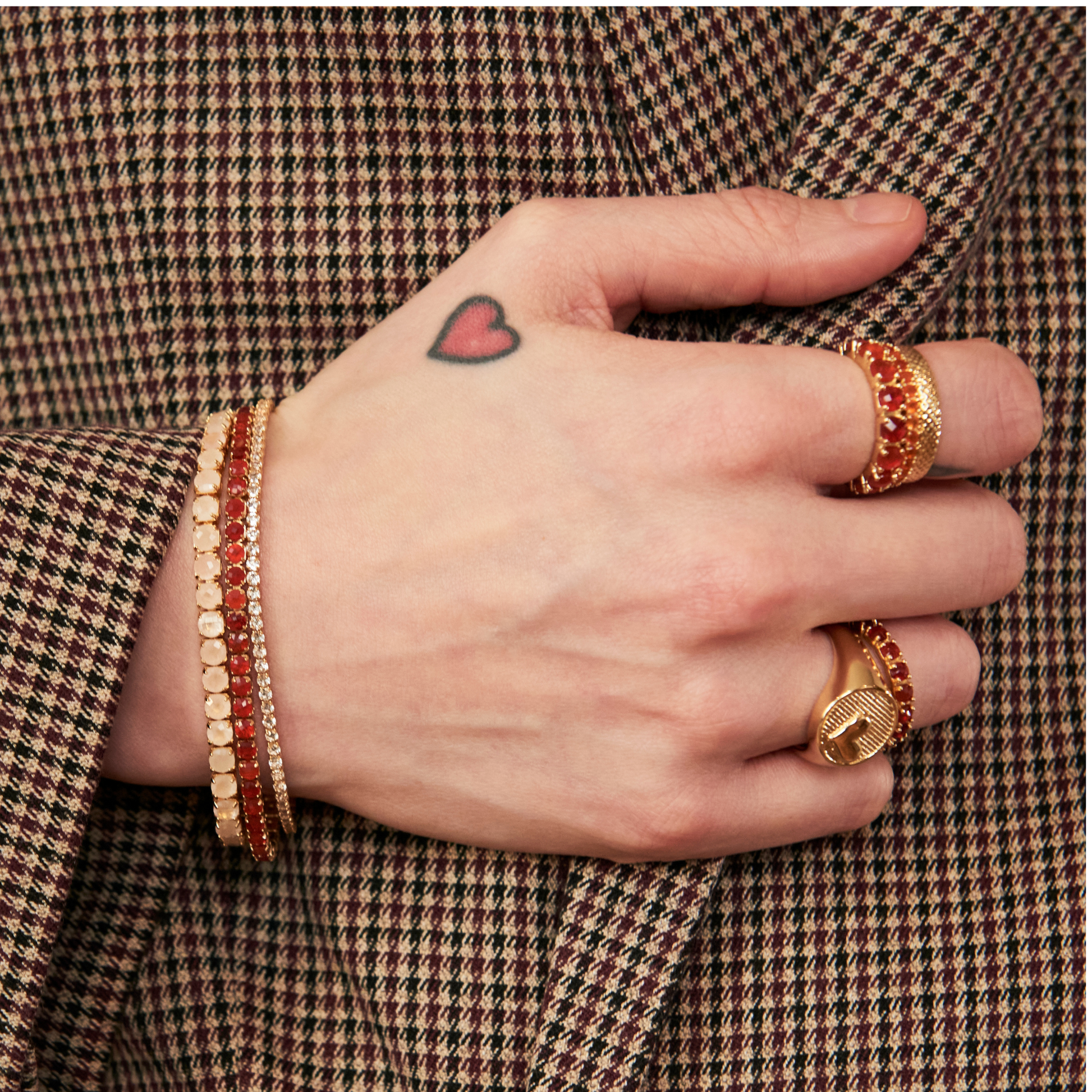 model hand wearing tennis bracelets and eternity band rings including the 4mm carnelian eternity band ring