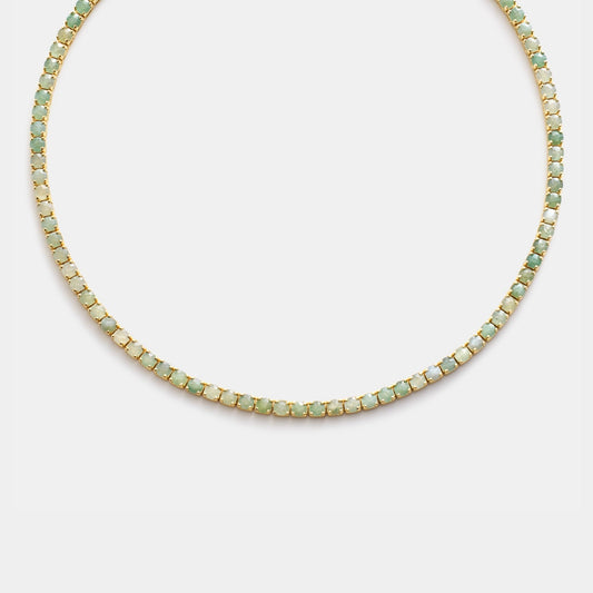 Necklace with small green beads on a light gray background