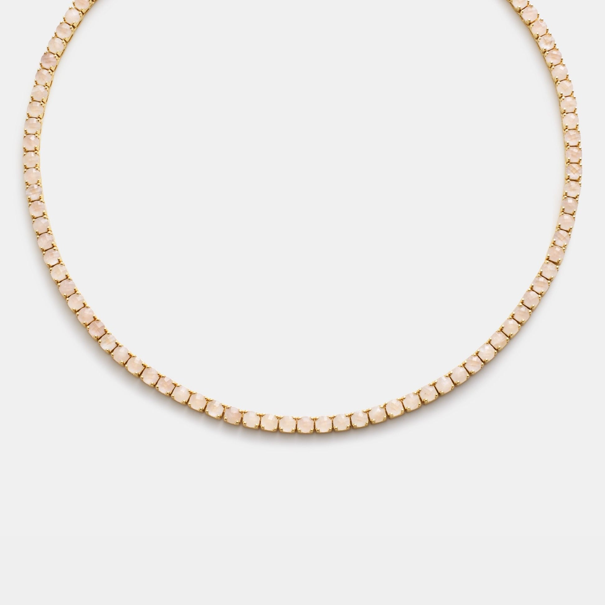 Gold beaded necklace on white background