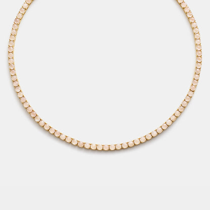 Gold beaded necklace on white background
