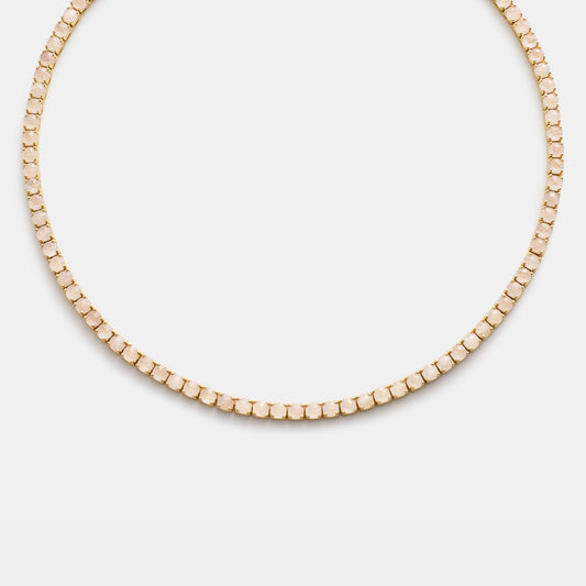 Gold beaded necklace on white background