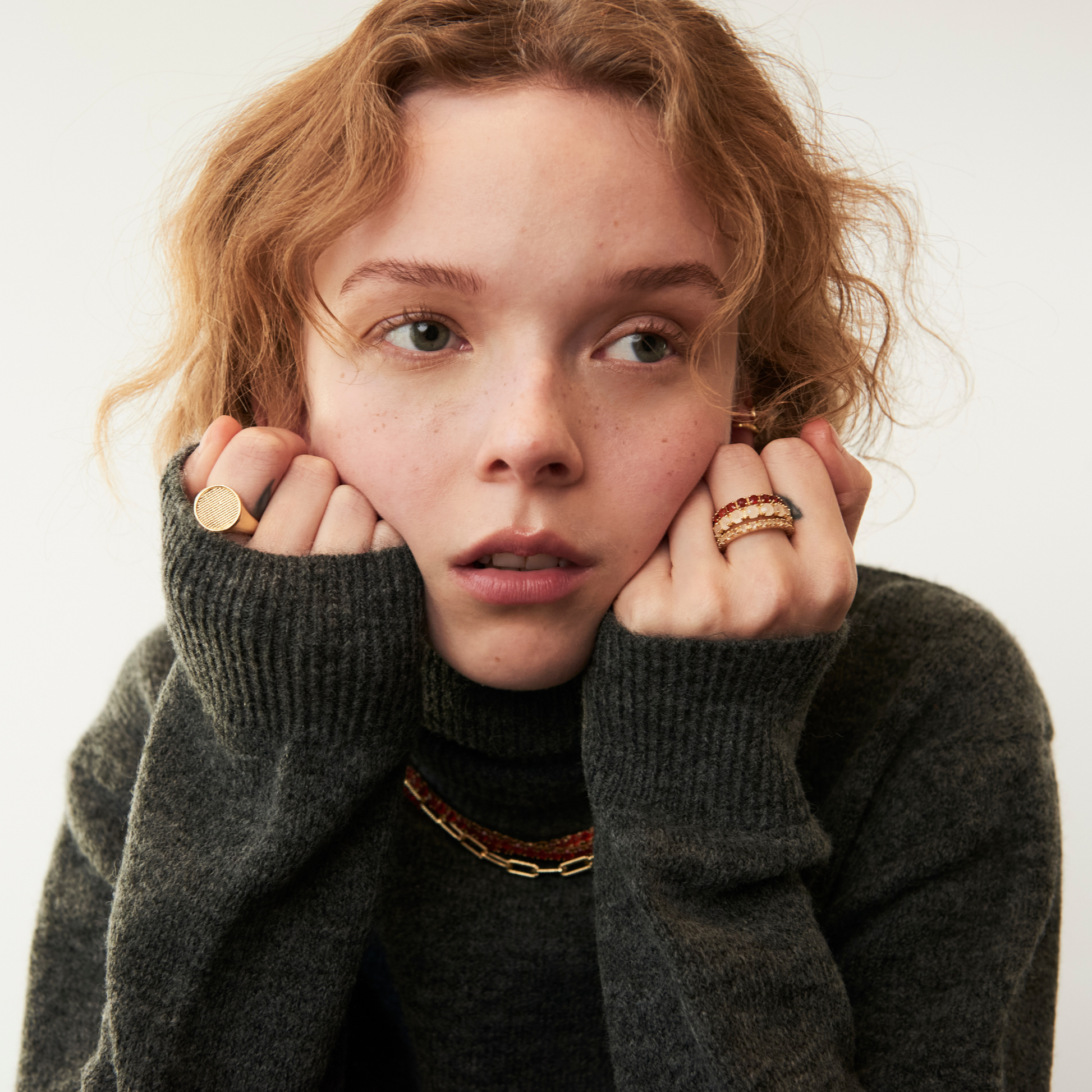 model wearing different gemstones eternity rings including the 3mm carnelian eternity band ring