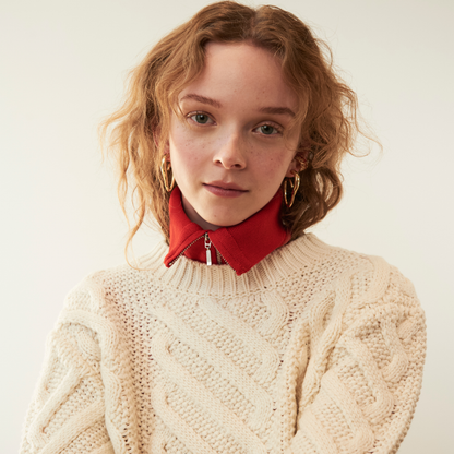 model wearing gold abstract heart hoop earrings