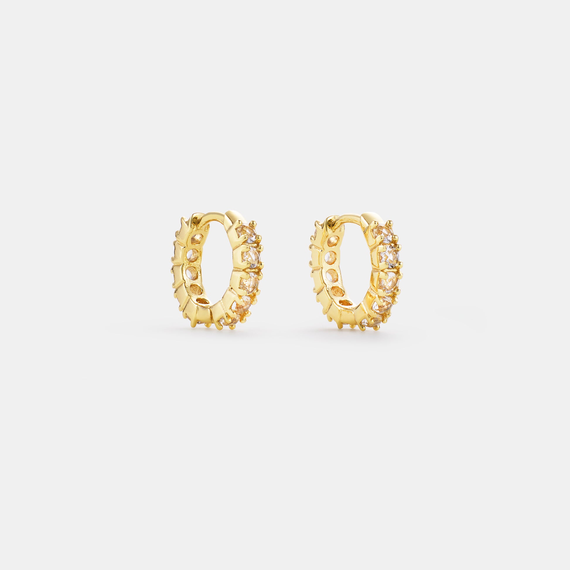 crystal quartz huggie hoop earrings on white background