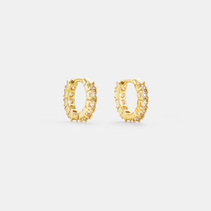 crystal quartz huggie hoop earrings on white background