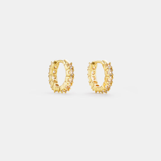 crystal quartz huggie hoop earrings on white background