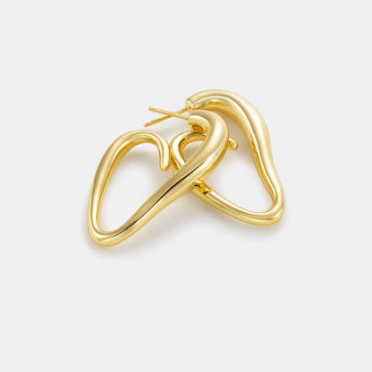 abstract heart hoop earrings laid on white background