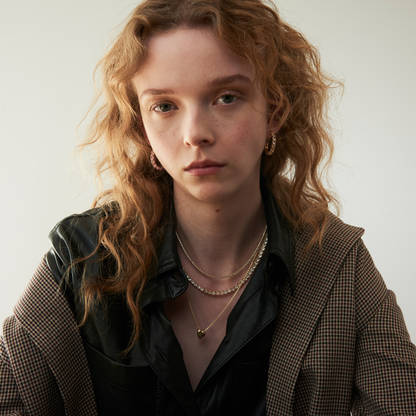 model wearing layered necklaces including the sculpted heart pendant necklace 